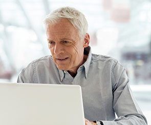 Older man using a laptop